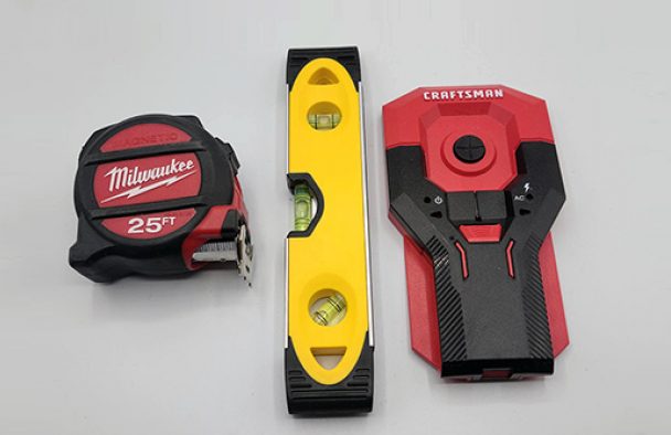 a level, measuring tape, and a stud finder.